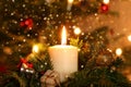 Christmas Concept - moody Advent Candle in Front of decorated Christmas Tree Royalty Free Stock Photo