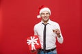 Christmas Concept - portrait happy Santa christmas businessman exciting with his gift over red background. Royalty Free Stock Photo
