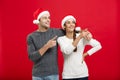 Christmas Concept - portrait lovely young couple finger on side