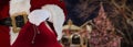 Christmas concept santa claus standing in a decorated town holding his sack full of gifts Royalty Free Stock Photo