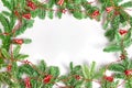 Christmas concept. spruce branches in the form of a frame, decorated with a red garland with bells and stars. Royalty Free Stock Photo