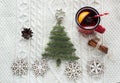 Christmas concept with spruce, fir-tree, cone and mulled wine on white knitted background. Holiday card. Royalty Free Stock Photo