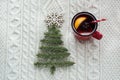 Christmas concept with spruce, fir-tree, cone and mulled wine on white knitted background. Holiday card. Royalty Free Stock Photo