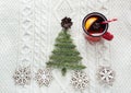 Christmas concept with spruce, fir-tree, cone and mulled wine on white knitted background. Holiday card. Royalty Free Stock Photo