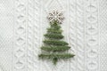 Christmas concept with spruce, fir-tree, snowflakes, on white knitted background. Holiday card. Vintage style. Royalty Free Stock Photo