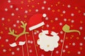 Christmas concept top view image. Santa claus beard and hat on red wooden background Royalty Free Stock Photo