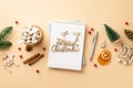 Christmas concept. Top view photo of diary merry christmas wooden text pen ornaments pine branch cone cup of cocoa with Royalty Free Stock Photo