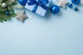 Christmas concept. Top view photo of giftbox with bow blue and white baubles silver star ornaments fir branches in snow and Royalty Free Stock Photo