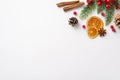 Christmas concept. Top view photo of pine cones dried orange slices cinnamon sticks anise mistletoe berries and fir branch in