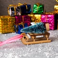 Christmas concept, toy santa sleigh, gift boxes on snow and blur bokeh, Empty wooden sled Royalty Free Stock Photo