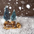 Christmas concept, toy santa sleigh, gift boxes on snow and blur bokeh, Empty wooden sled Royalty Free Stock Photo