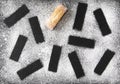 Christmas concept - traditional French pastry financier- cake on a black board with traces of icing sugar, a symbol of a delicious Royalty Free Stock Photo