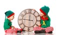 Christmas concept. Two little elf helper of Santa with clock iso Royalty Free Stock Photo