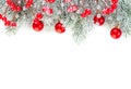 Christmas concept. Xmas border composition with red glass baubles, holly berries and green fir branch isolated on white background Royalty Free Stock Photo