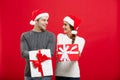 Christmas Concept - Young attractive couple giving gifts to each other celebrating in Christmas day Royalty Free Stock Photo