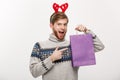 Christmas Concept - Young handsome beard man happy with shopping bag in the hand isolated on white. Royalty Free Stock Photo