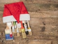 Christmas construction tools on wooden background. Brush in a cap of Santa Claus. Royalty Free Stock Photo