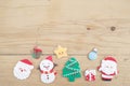 Christmas cookie. A hand holding a festive gingerbread cookie of a Santa Claus with abstract blur background of a giant Santa Clau