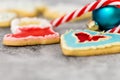 Christmas cookies, bauble and candy cane on grey background Royalty Free Stock Photo