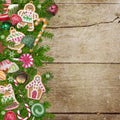 Christmas cookies, candy, pine branches on a wooden background