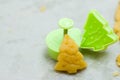 Christmas cookies for children, making gingerbread in shape of fir tree. Raw dough and form for preparation cookie. New year treat Royalty Free Stock Photo