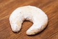 Christmas cookies: christmas pastries: single vanilla crescent on old board