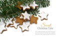 Christmas cookies, cinnamon stars with fir branches on white background, sample text in the copyspace