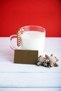 Christmas cookies with cup of milk at a red background