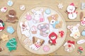 Christmas cookies. Cute gingerbread cookies in Christmas tree, Santa Claus, Stars and presents on the wooden background Royalty Free Stock Photo