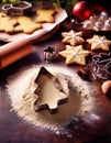 Christmas cookies decorated with icing and sprinkles, on a wooden table with baking tools Royalty Free Stock Photo
