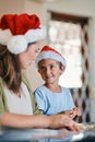 These Christmas cookies have been in our family for generations. an adorable little boy baking with his mother during Royalty Free Stock Photo