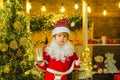 Christmas cookies and milk. Little Santa Claus kid with beard and mustache. Santa in home. Santa Claus - bearded funny