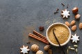 Christmas cookies, nuts and aromatic spices on dark background