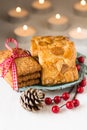 Christmas cookies ona vintage plate with holly berries and pine cone on white table Royalty Free Stock Photo