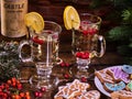 Christmas cookies plate and two glasses mug with bottle. Royalty Free Stock Photo