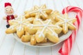 Christmas cookies in a plate with a wooden Santa Claus and a candy cane Royalty Free Stock Photo