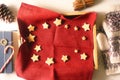 Christmas cookies on the red napkin in the tray with different accessorizes top view