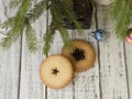Christmas cookies with spices on wooden table with fir tree branches decorated with spruce balls. Festive New Years Royalty Free Stock Photo