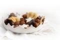 Christmas cookies and sweets like homemade cinnamon stars, marzipan balls, chocolate and biscuit in a pottery crown