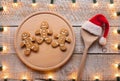 Christmas cookies on wooden plate and spoon with santa hat Royalty Free Stock Photo