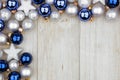 Christmas corner border of blue and silver ornaments on gray wood Royalty Free Stock Photo
