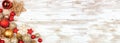 Christmas corner border of red and gold ornaments on a white rustic white wood banner background Royalty Free Stock Photo