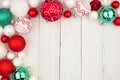 Christmas corner border of red, green and white ornaments on white wood Royalty Free Stock Photo