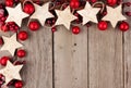 Christmas corner border with rustic wood star ornaments and baubles over aged wood