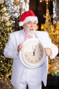 Christmas countdown arriving. wait for xmas presents. santa man hold alarm clock. new year midnight. time for party Royalty Free Stock Photo