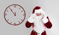 Christmas countdown. Clock showing five minutes to midnight near Santa Claus on light background