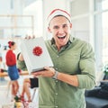 Christmas, coworking office and gift for excited and happy business man during holiday celebration with secret Santa Royalty Free Stock Photo