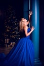 Christmas cozy atmosphere at event, pretty lady in blue dress Royalty Free Stock Photo