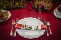 Christmas cracker on plate with red wine on Christmas dinner table Royalty Free Stock Photo