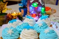 Christmas cream cakes and candles close up on the table with colored lights